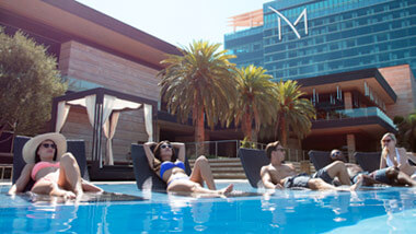 Guests lounge in pool chairs in the infinity pool outside The M Resort in Las Vegas, Nevada.