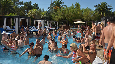Guests at DayDream Pool Club at the M Resort dive into the pool near Las Vegas.