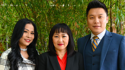 Three people posing for picture