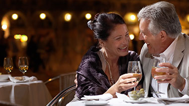 A couple enjoys glasses of wine