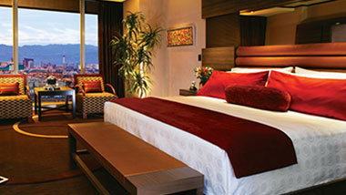 A classic M Resort hotel room with a king-sized bed and view of the Las Vegas Strip.